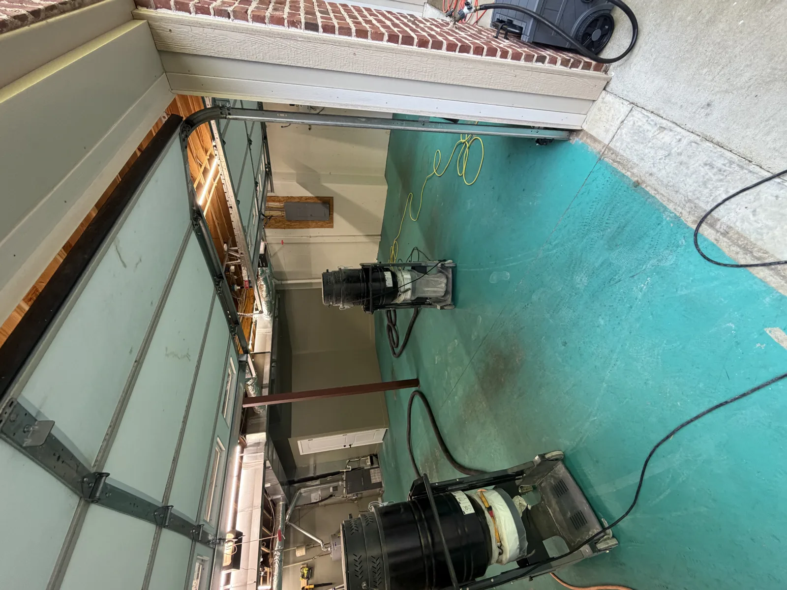 Grey flake floor finished under exposed timber joists in a basement