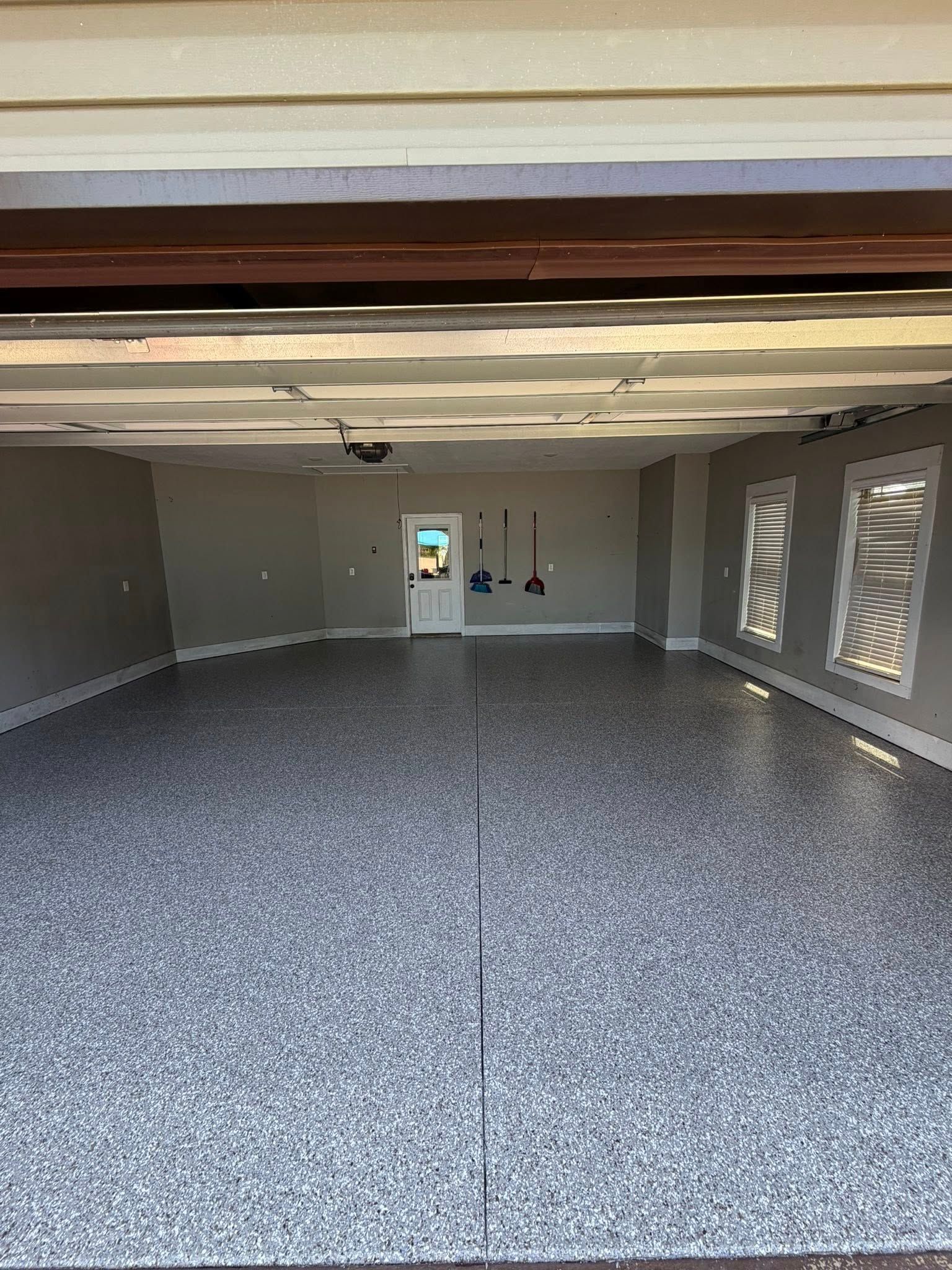 Gray and white flake floor in a garage seen from the open door