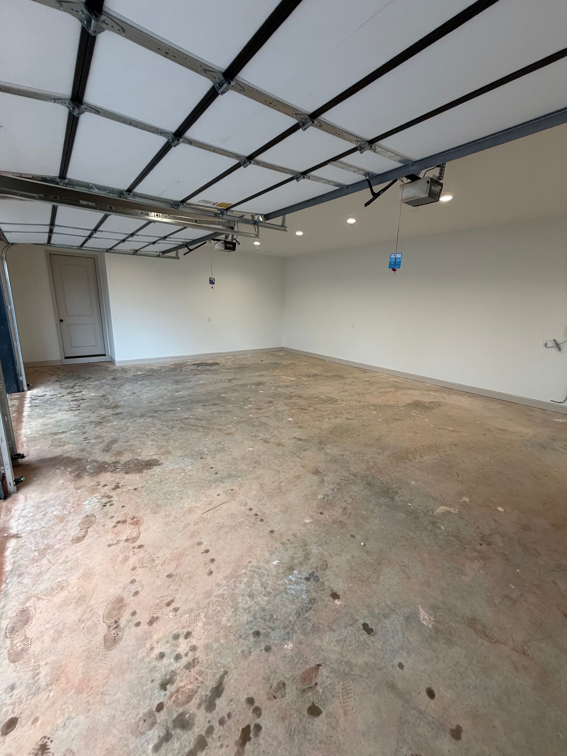 Bare gray concrete garage slab before coating