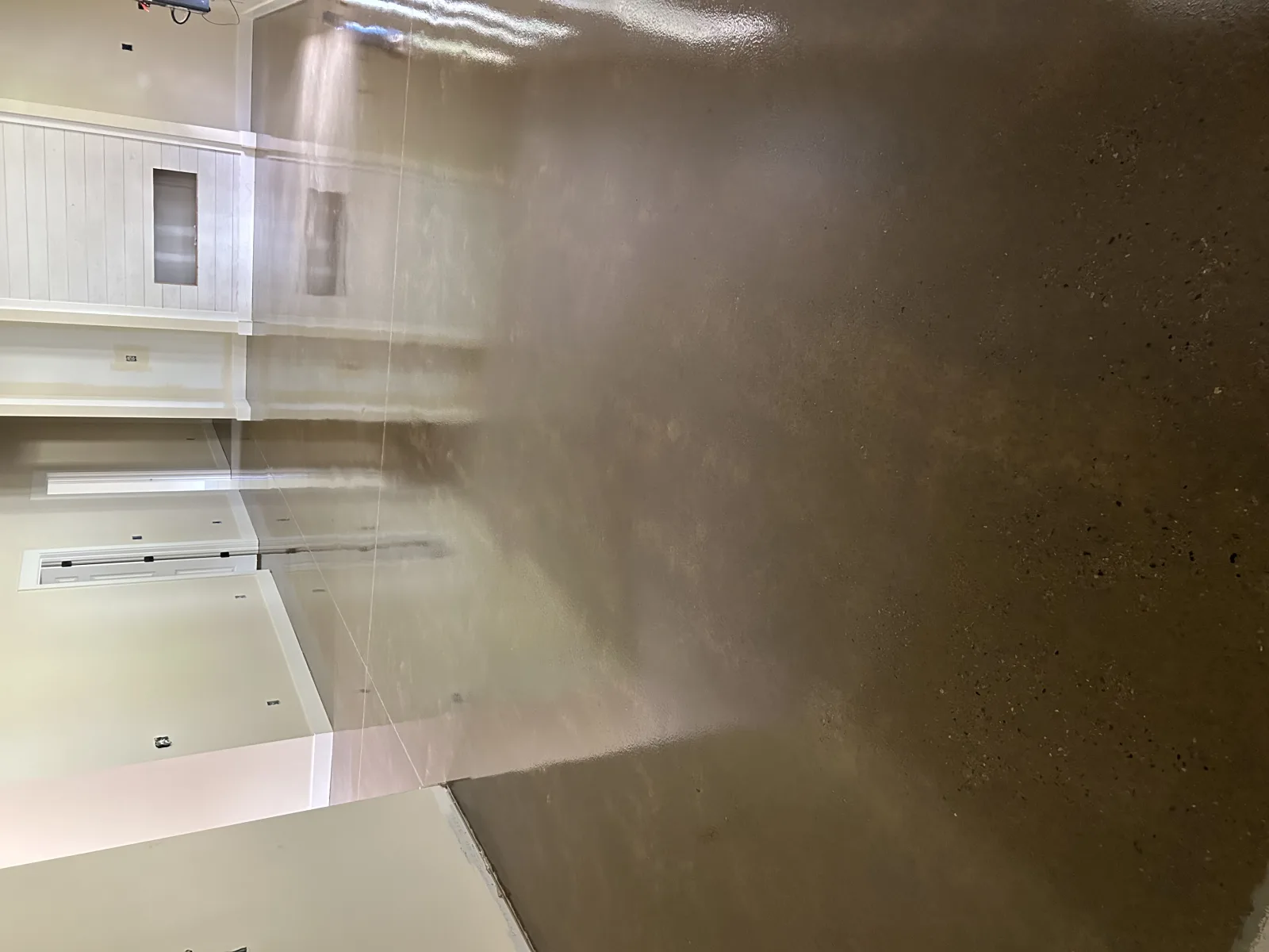Broken ceramic tile lifted off a floor with a hammer and scraper during demolition