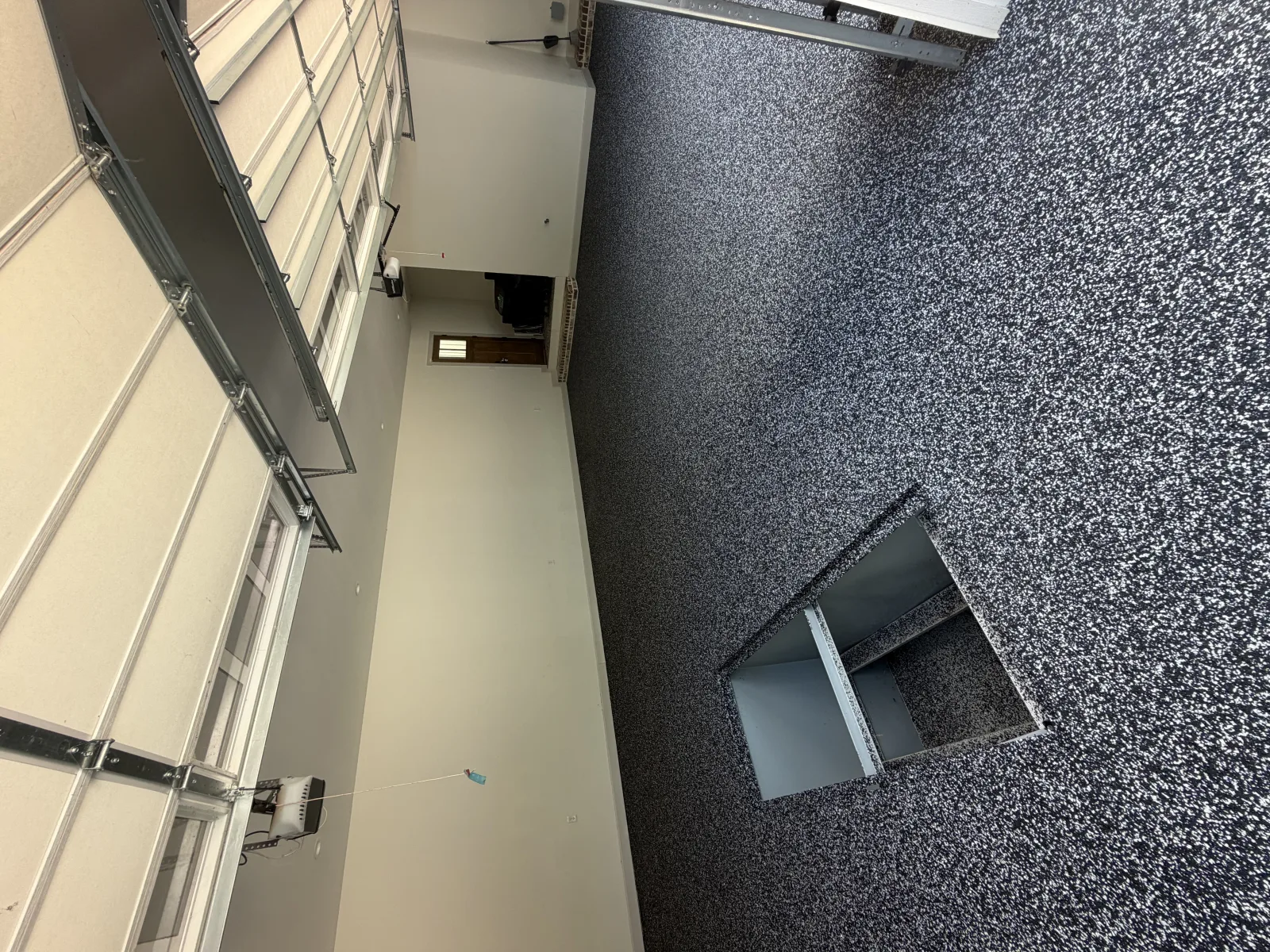 Cream and black flake floor across an office room with pale yellow walls
