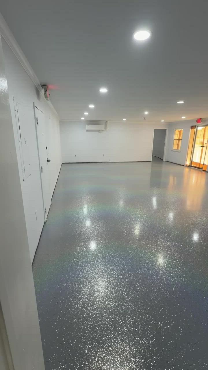 Gray quartz broadcast floor running the length of a bright commercial room