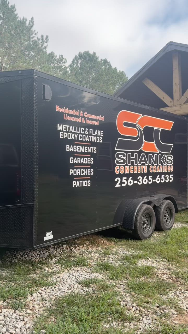 The black Shanks Concrete Coatings trailer lettered in orange with the phone number